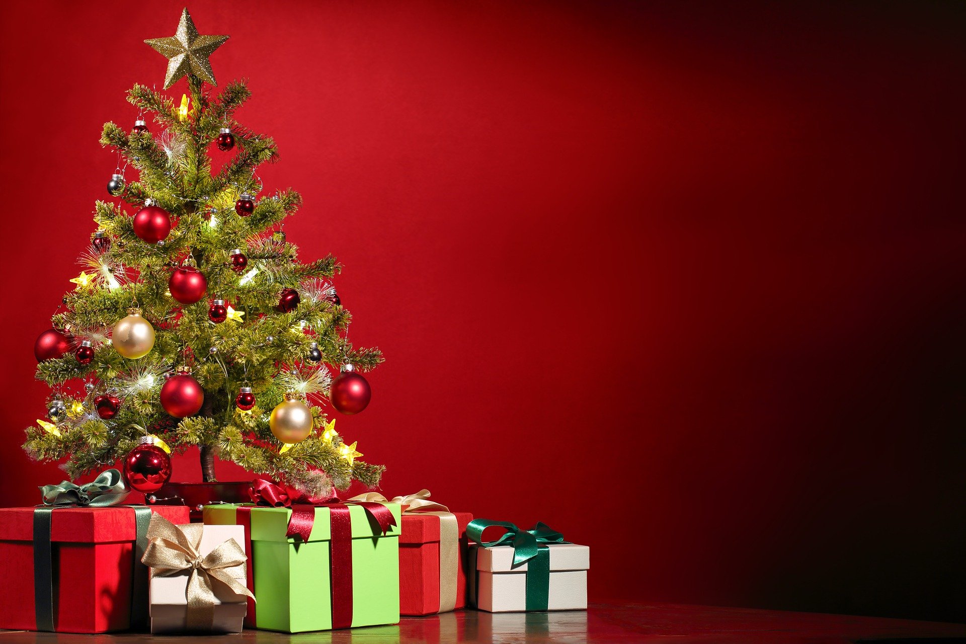 a christmas tree surrounded by christmas presents