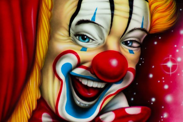 A painted image of a close-up on a clown's face. He is poking his head around a stage curtain.