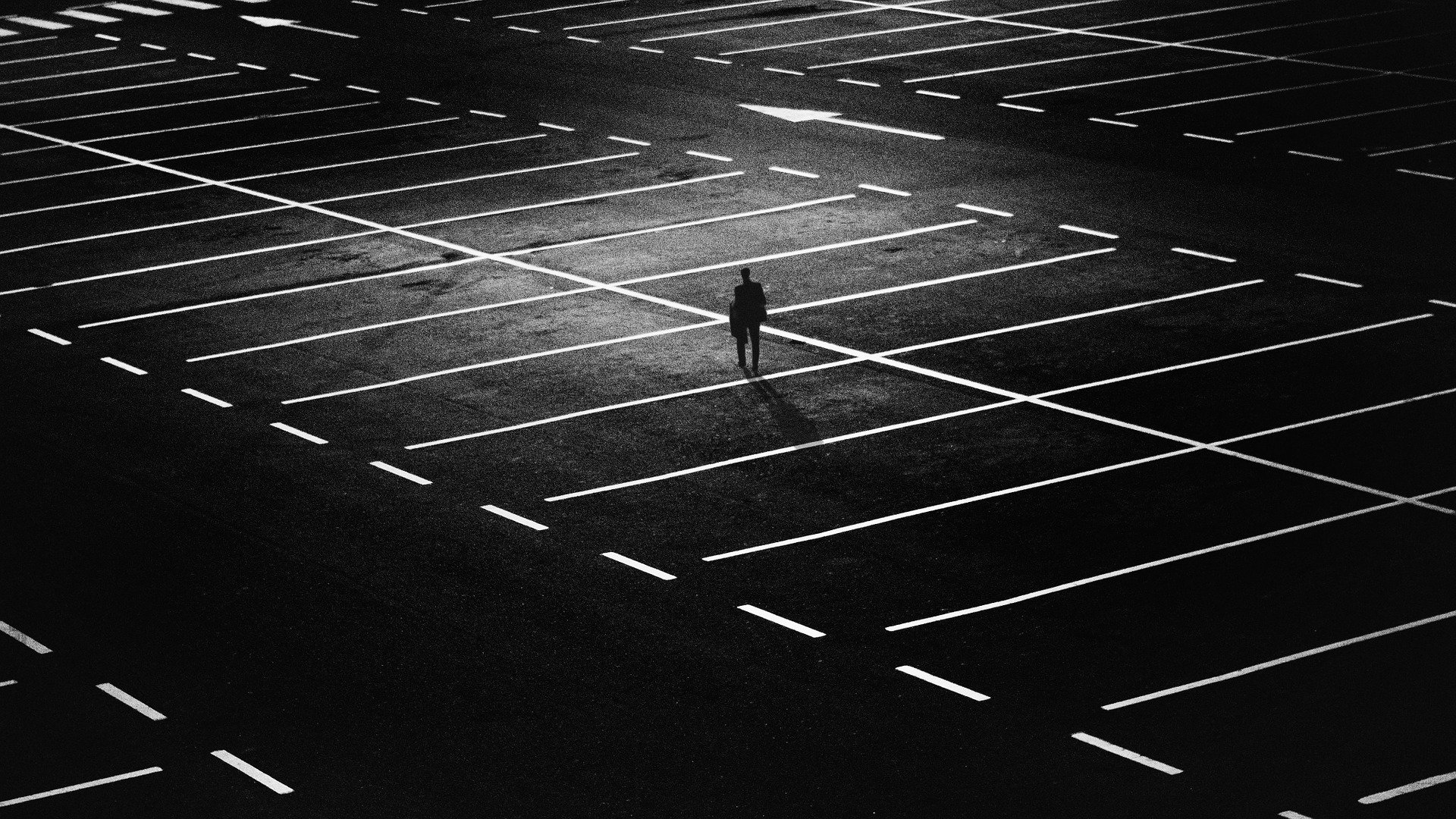 a personal alone in a large car park