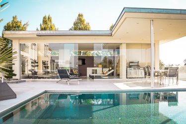 An expensive looking house with a pool.