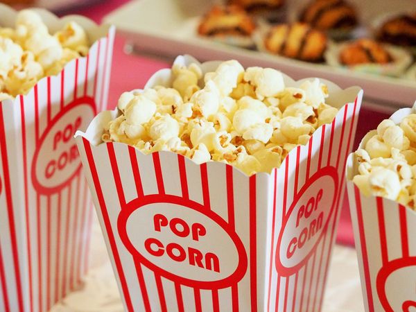 Popcorn in cinema-style boxes with red stripes.