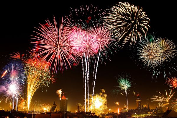 Fireworks going off over a city.