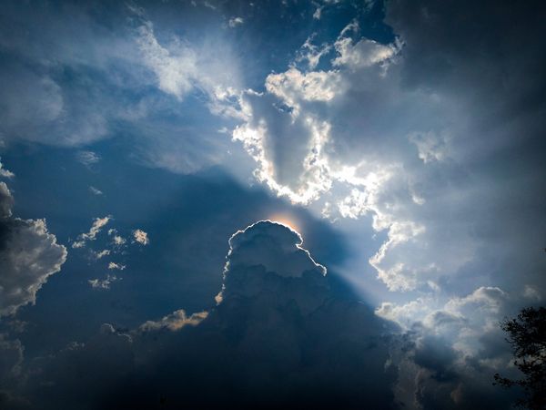 A cloud in front of the sun creating a silver-lining effect.