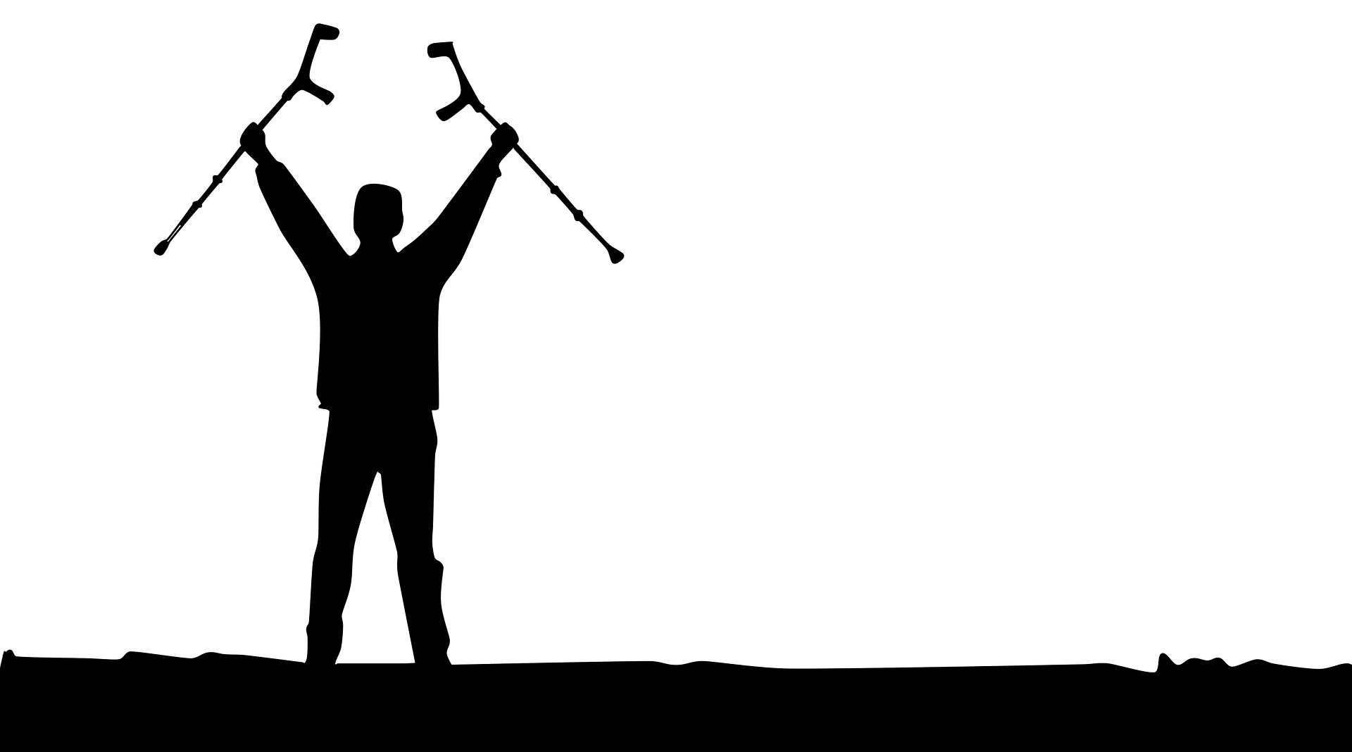 a silhouette of a man holding up his crutches as if he is suddenly able to walk