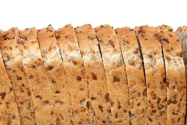 A side view of several pieces of sliced multigrain bread.