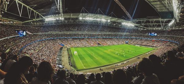 A soccer stadium packed with fans during a night game.